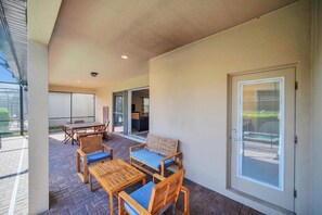 Relax on the patio with comfortable seating and a view of the street.