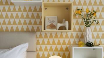 Cozy retreat with a bed, nightstand, and shelf, offering a peaceful space to unwind.