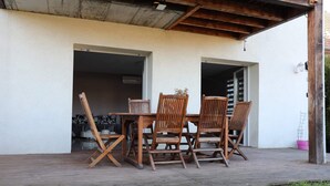 An outdoor wooden deck with a table and four chairs. - Apartment near Basel / Mulhouse Airport (Saint-Louis)