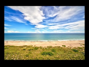 A beach with a clear sky and ocean. - SUMMER RATES! OV3 LOCATION! 2 MINUTE WALK TO BEACH PRIME LOCATION TO EVERYTHING! (Fort Pierce)