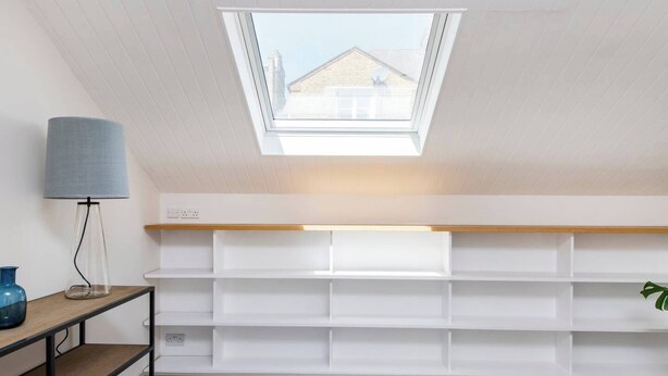 A room with a skylight, white shelving, a lamp, and a plant. - 3-bed Mews House, Battersea (London)