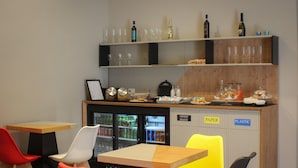A restaurant with a bar area, seating, and a refrigerator with mixed waste bins. - Be Italian Room Bovio 23 (Naples)