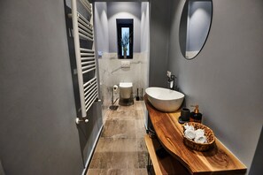 A modern bathroom with a wooden vanity, a large sink, and a mirror. - Metropole Apartments Royal Residence (Bucharest)