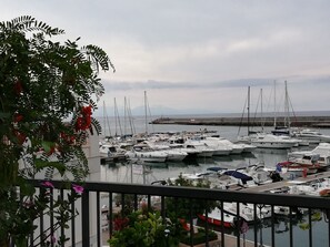 A marina with multiple boats docked, surrounded by greenery and a clear sky. - Central apartment with sea view 150 meters from the Bellavista Residence beach (Marina di Camerota)