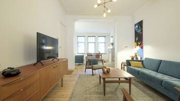 Deluxe Apartment | Living room | 120-cm flat-screen TV with cable channels, TV
