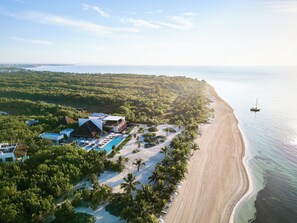 A resort with a pool, beach, and ocean view.