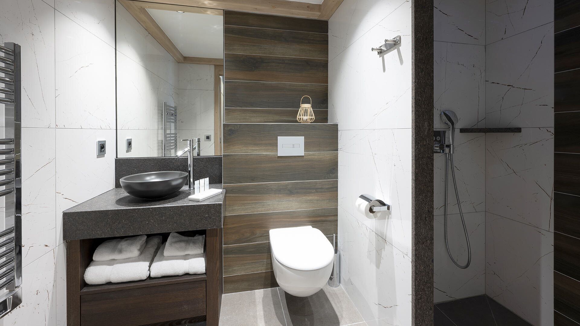 A modern bathroom with a large sink, a toilet, and a shower area.