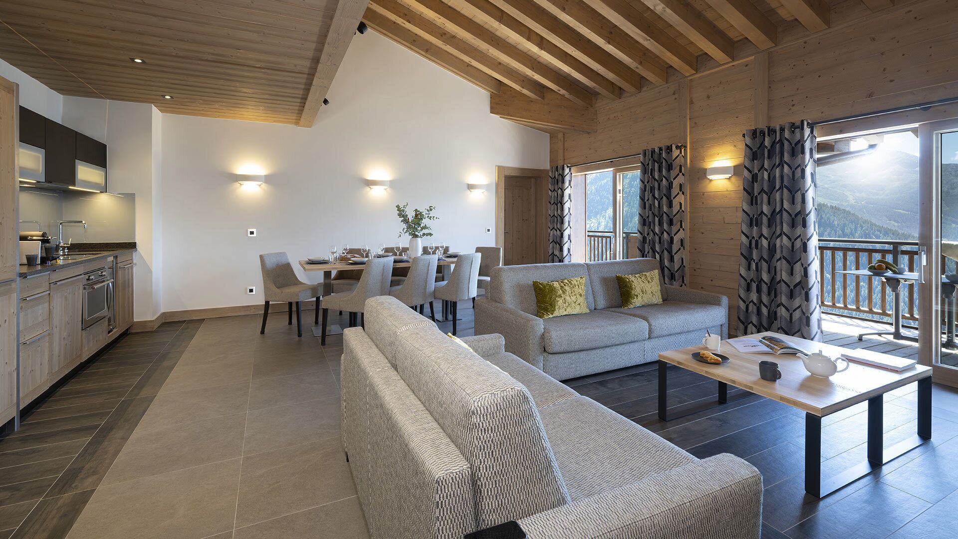 A modern living room with a sofa, coffee table, and dining area.