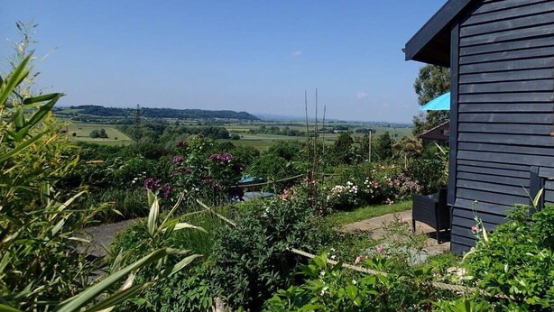 A house with a view of a green landscape. - Rose Lodge, Eco Lodge with Hot Tub (Langport)