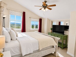 A bedroom with a bed, a ceiling fan, a television, and windows with curtains. - Spacious - Three king rooms, two living rooms in a  quiet neighborhood (Alamosa)