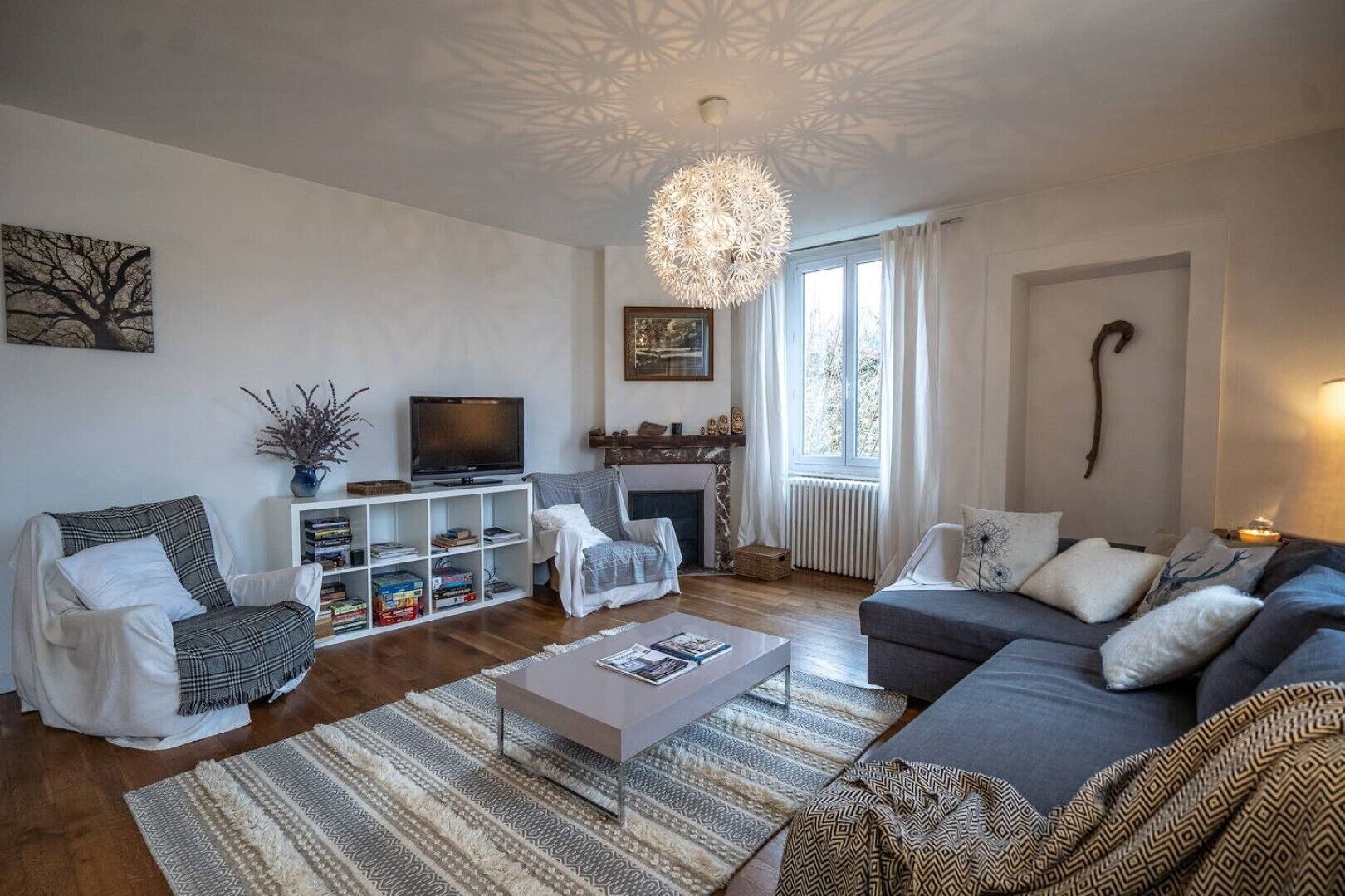 A living room with a fireplace, a television, and a sofa.