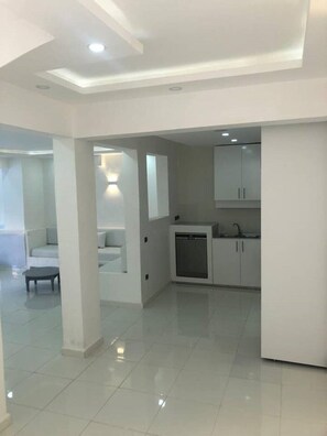 A modern, spacious living area with a kitchen and dining space. - - Imi White House - (Imi Ouaddar)