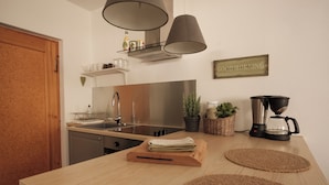A kitchen with a wooden countertop, stainless steel appliances, a coffee maker, and a 'Good Morning' sign. - Vacation apartment CramerTwo rooms for 4 persons (Gerolzhofen)