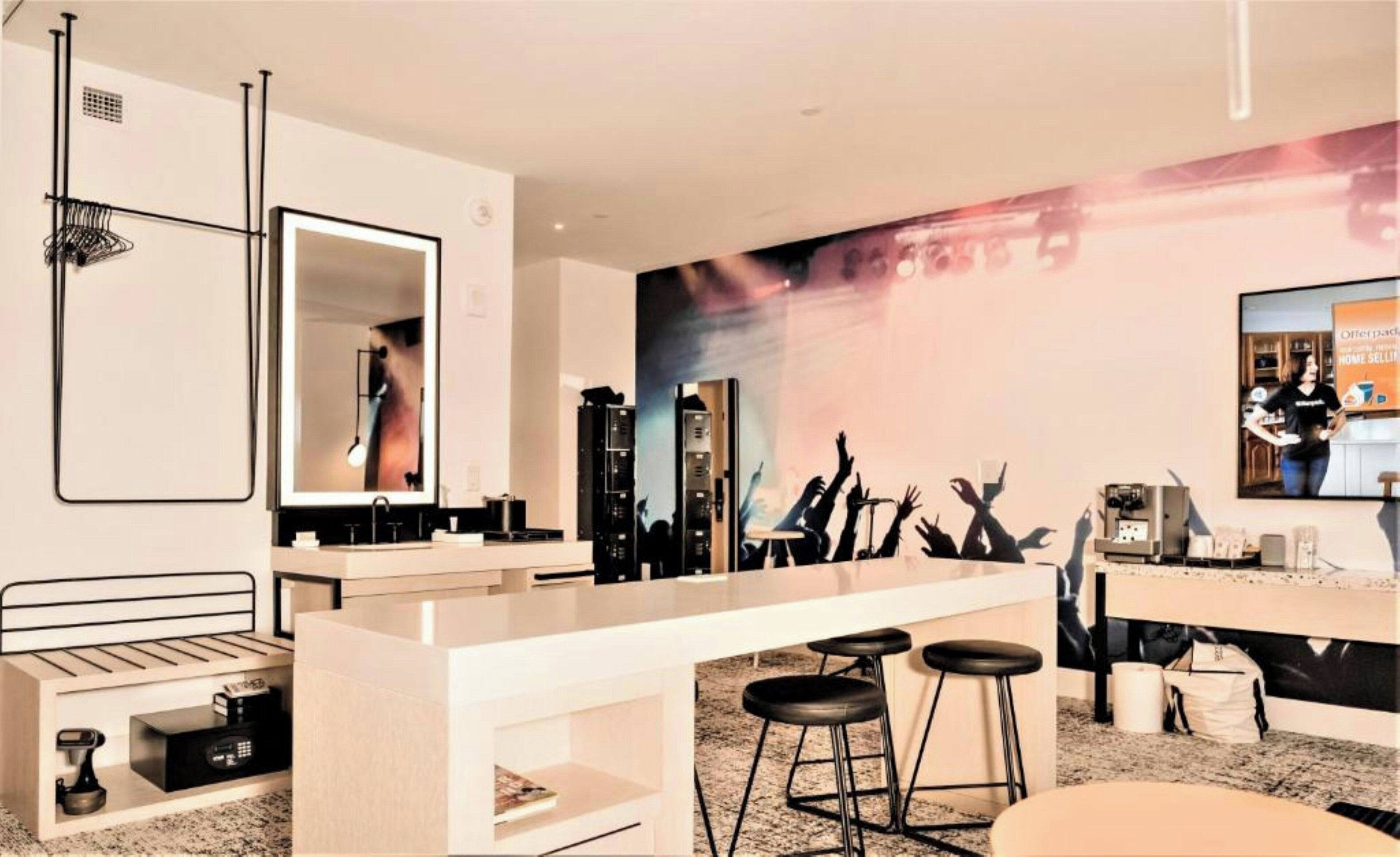 A modern bathroom with a large mirror, a sink, and a vanity with a countertop.