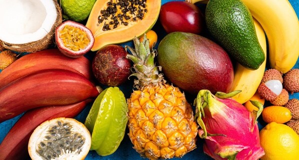 A variety of tropical fruits including mango, pineapple, and dragon fruit.