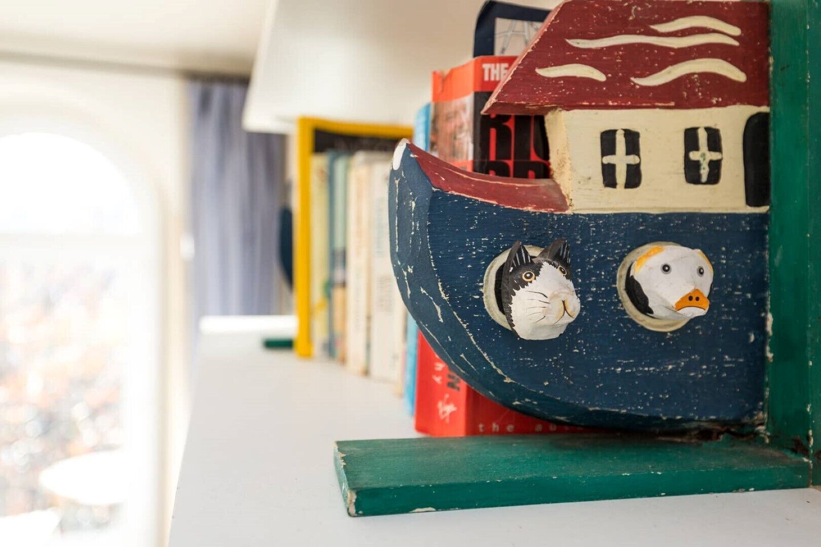 A bookshelf with colorful, animal-themed bookends.