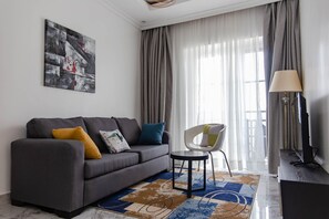 Apartment, 1 Bedroom | Living area | 42-inch flat-screen TV with cable channels, TV, DVD player - Kasi Apartments (Kigali)