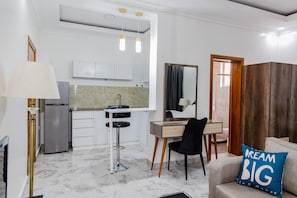 Studio | Living room | 42-inch flat-screen TV with cable channels, TV, DVD player - Kasi Apartments (Kigali)