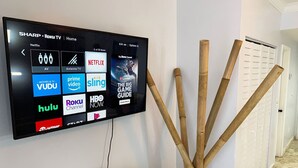 A flat-screen TV mounted on a wall displaying various streaming services. - Right on the Beach Ocean Dr Secured Condo 206 (Miami Beach)