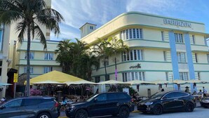 A hotel with a curved facade, named BARBIZON, featuring outdoor seating and palm trees. - Right on the Beach Ocean Dr Secured Condo 206 (Miami Beach)