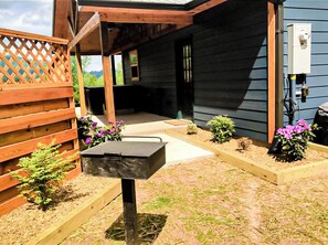 Enjoy the serene outdoor space with a wooden deck, garden, and mailbox.