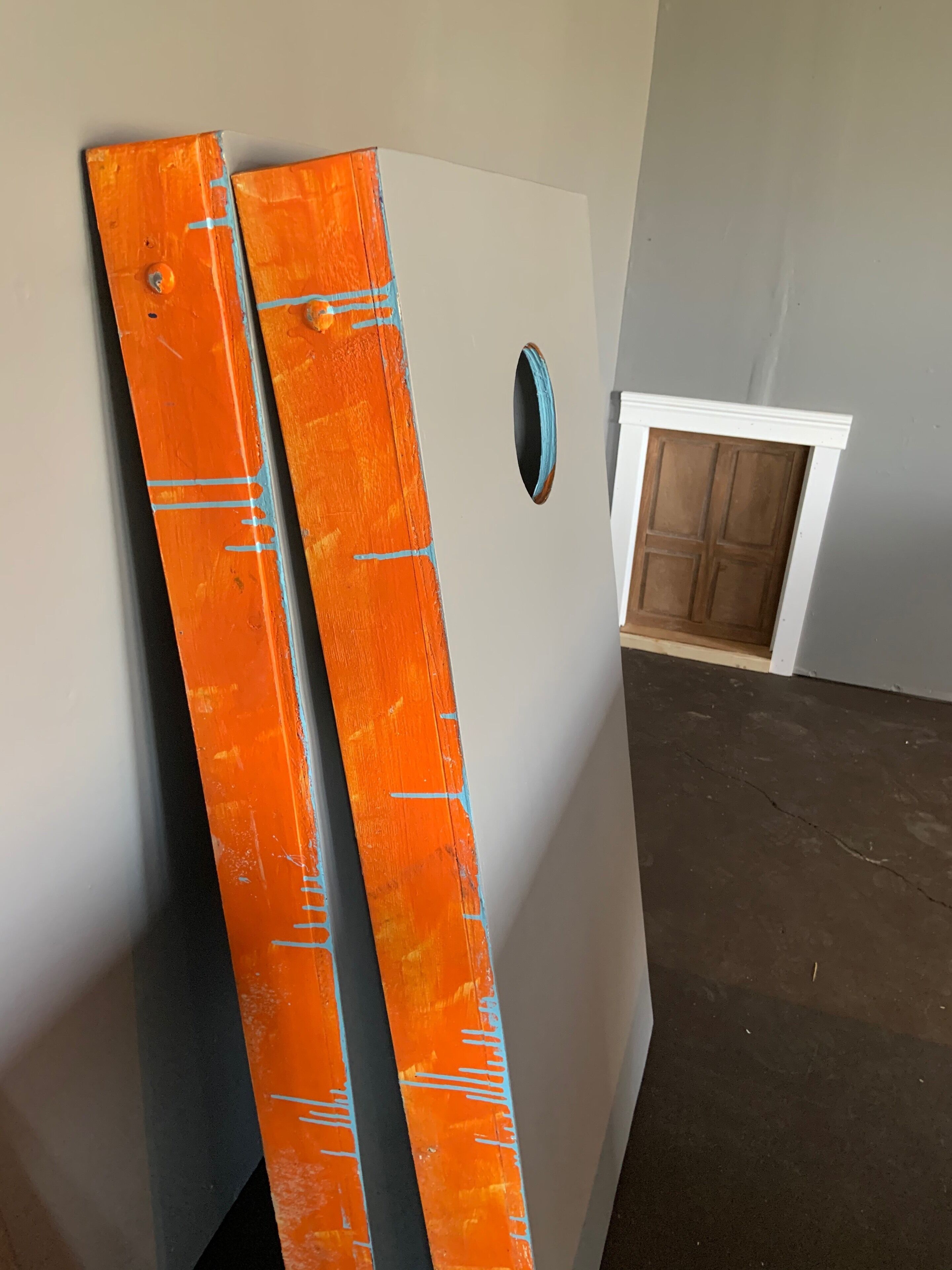 Corn hole boards and secret door in the background 