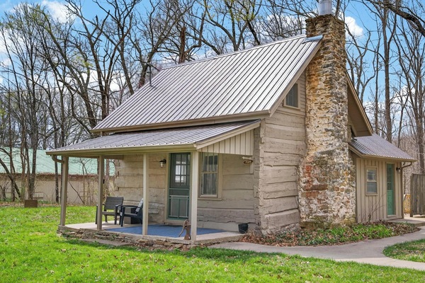 Cozy cabin retreat with rustic stone fireplace and porch