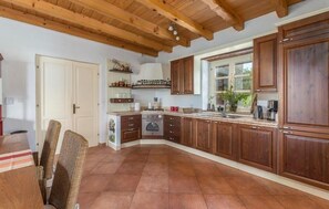 Enjoy cooking in this well-equipped kitchen with a central island and modern appliances, including a stove and dishwasher.