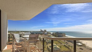 A balcony with a view of the ocean and a swimming pool. - Surfside 803 - Gulf View, Community Pool, Hot Tub, Tennis, Easy Beach Walkover! (Miramar Beach)