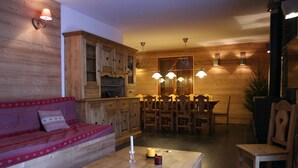Un interior de madera acogedor con sofá, mesa de comedor y sillas.