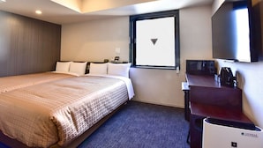 A hotel room with a large bed, a desk with a coffee maker, a TV, and a window with a view of the sky. - Hotel Livemax Hakata Nakasu (Fukuoka)