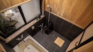 A small bathroom with a bathtub, a shower, and a window. - Kyokoi Reishikamogawa (Kyoto)