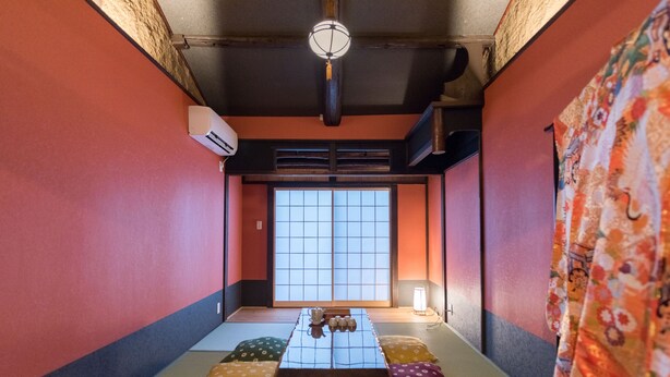 A tatami mat room with a low table, cushions, and a sliding door. - Kyokoi Kiyomizusaryou (Kyoto)