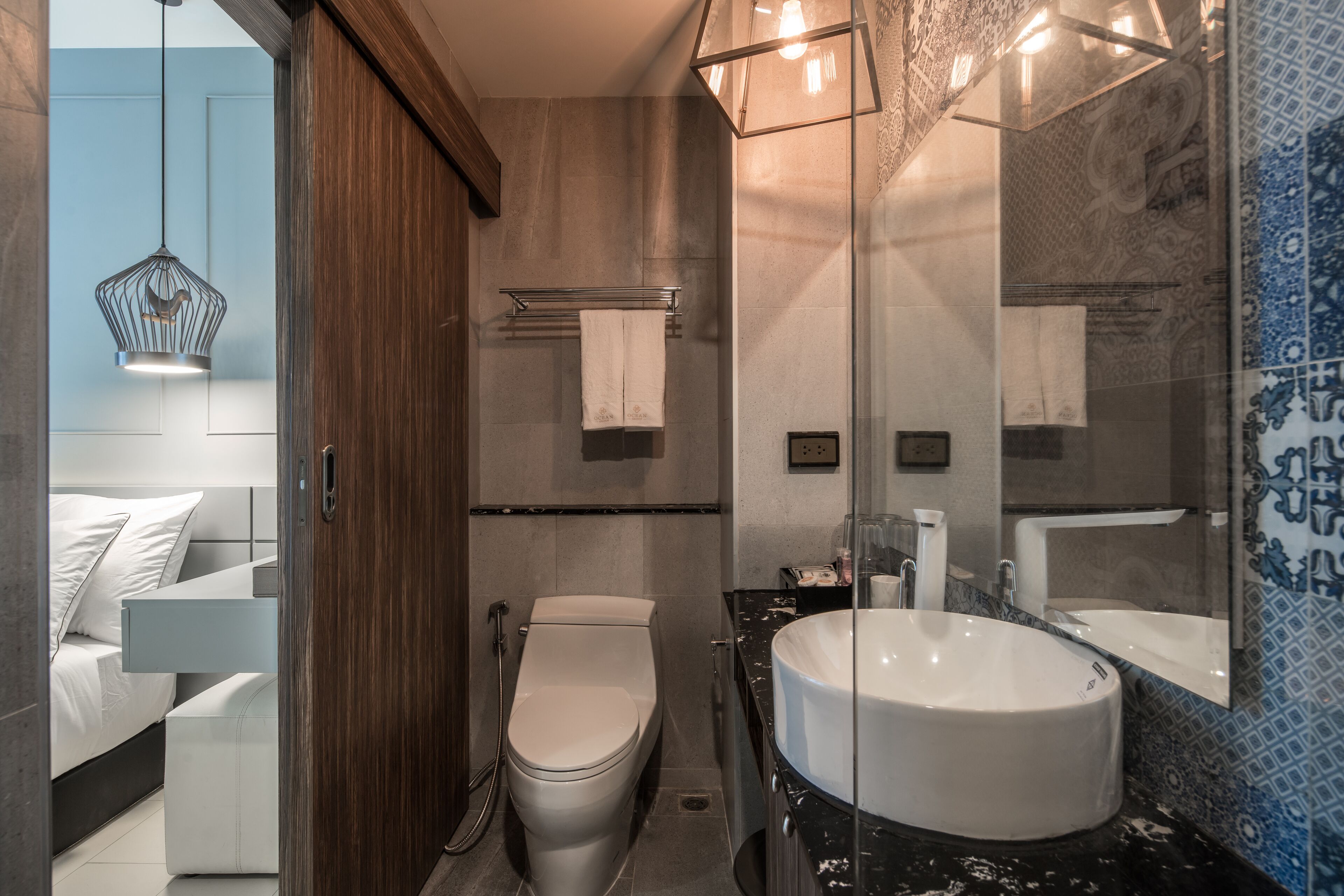 A modern bathroom with a toilet, sink, and shower.