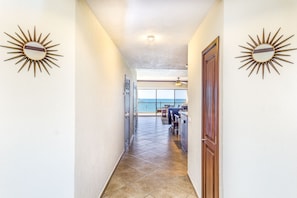 Stunning ocean views await from the balcony, where a seating area invites relaxation.