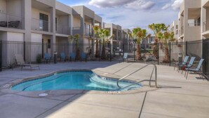 A modern hotel with a swimming pool, outdoor seating, and a clear sky. - The Lofts #36 | Townhome Pool Resort (Saint George)