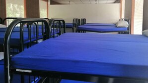 A dormitory room with bunk beds and a single bed. - Hotel O Otternest @ Gunung Pulai 2 (Pekan Nanas)