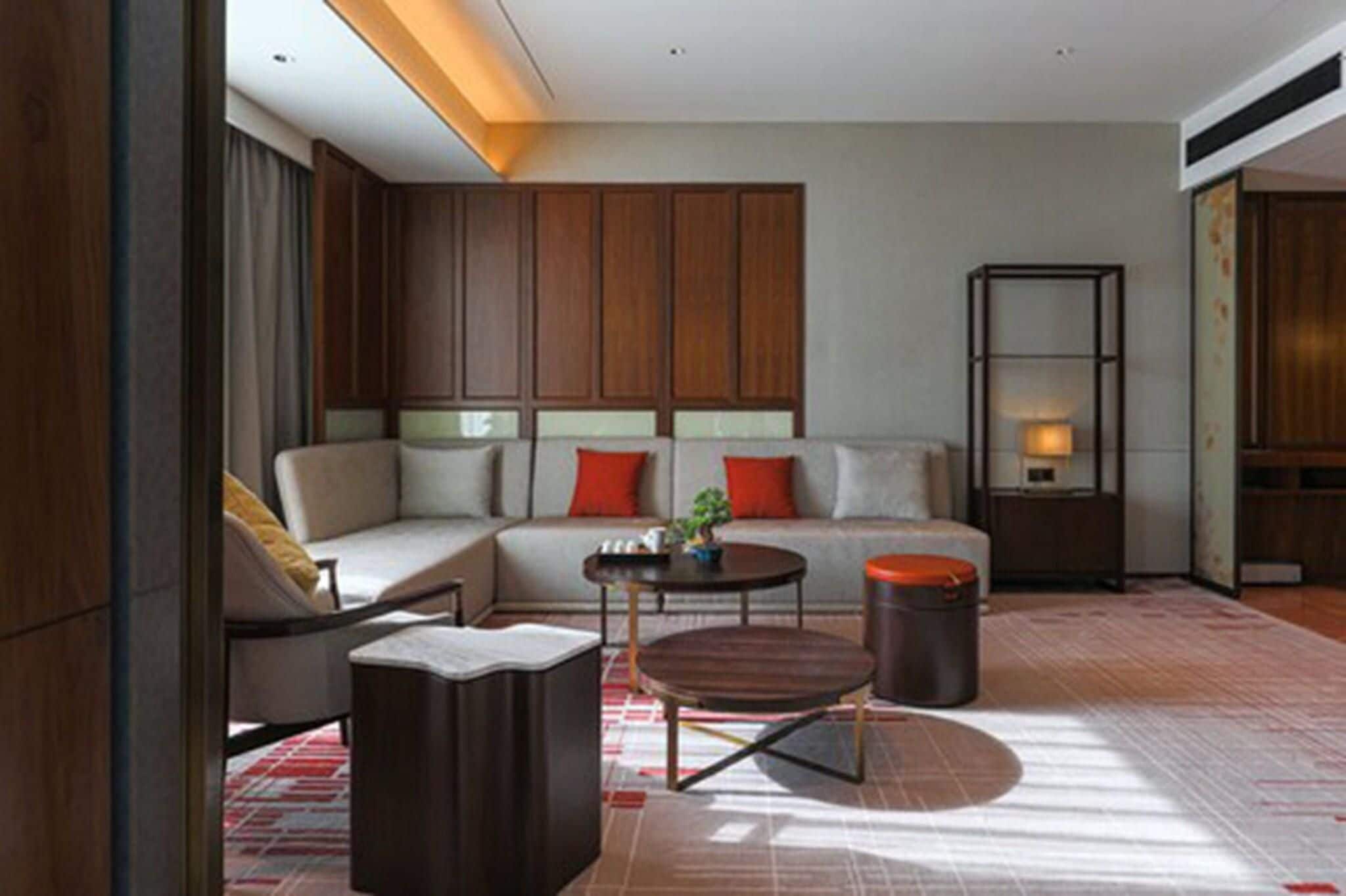 A modern living room with a sofa, coffee table, and a small side table.