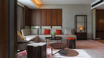 A modern living room with a sofa, coffee table, and a small side table.