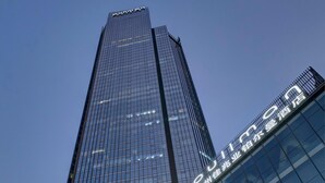 A tall, modern building with a glass facade and a prominent sign indicating a hotel. - Pullman Huizhou Kaisa (Huizhou)
