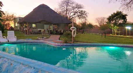 Outdoor pool, pool loungers. Mount Hermon Safari Cottages