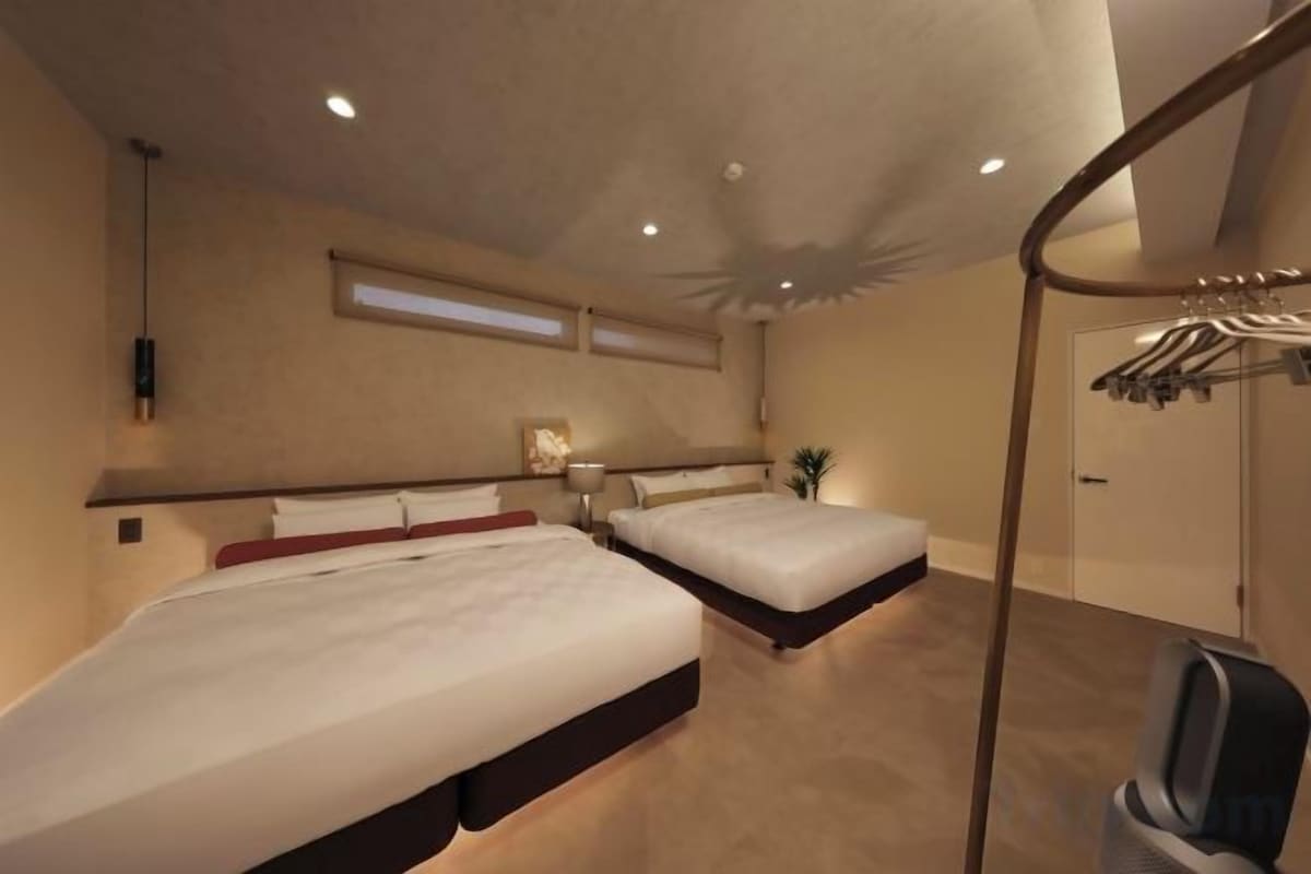 A bedroom with two beds, a TV, and a walk-in closet.