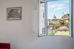 A room with a large window offering a view of a historic dome and surrounding buildings. - Modern studio with panoramic terrace, by Campo de’ Fiori - Wifi, Independent Heating, A/C (Roma)