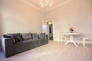 Relax in this inviting living space with a comfortable sofa and dining area.