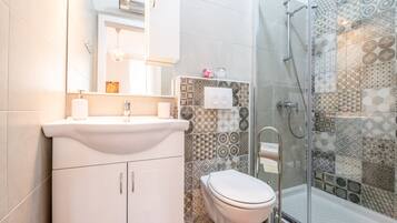 Shower, hair dryer, slippers, towels