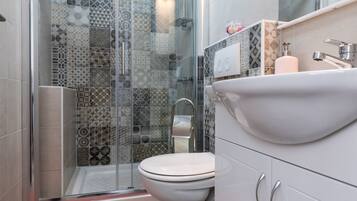 Shower, hair dryer, slippers, towels
