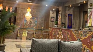 A hotel lobby with a reception desk, a chandelier, and a seating area with patterned cushions. - Hotel River Valley (Punakha)