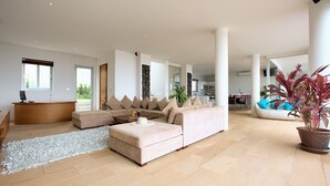 A spacious living room with a large sectional sofa, a coffee table, and a potted plant. - 6 Bedroom Luxury Sea View Villa Moonrise SDV079B-By Samui Dream Villas (Koh Samui)