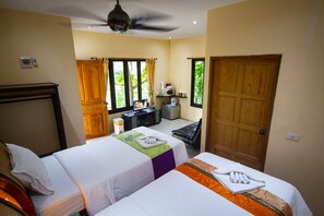 A hotel room with two beds, a desk with a computer, a microwave, and a view of greenery outside. - 1 Bedroom Beach Bungalow Koh Phangan SDV235-By Samui Dream Villas (Ko Pha-ngan)