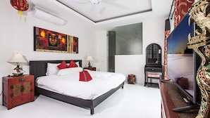A bedroom with a bed, a nightstand, a lamp, a TV, and artwork on the wall. - 6 Bedroom Twin Villas Ban Tai near Beach SDV260/261-By Samui Dream Villas (Koh Samui)